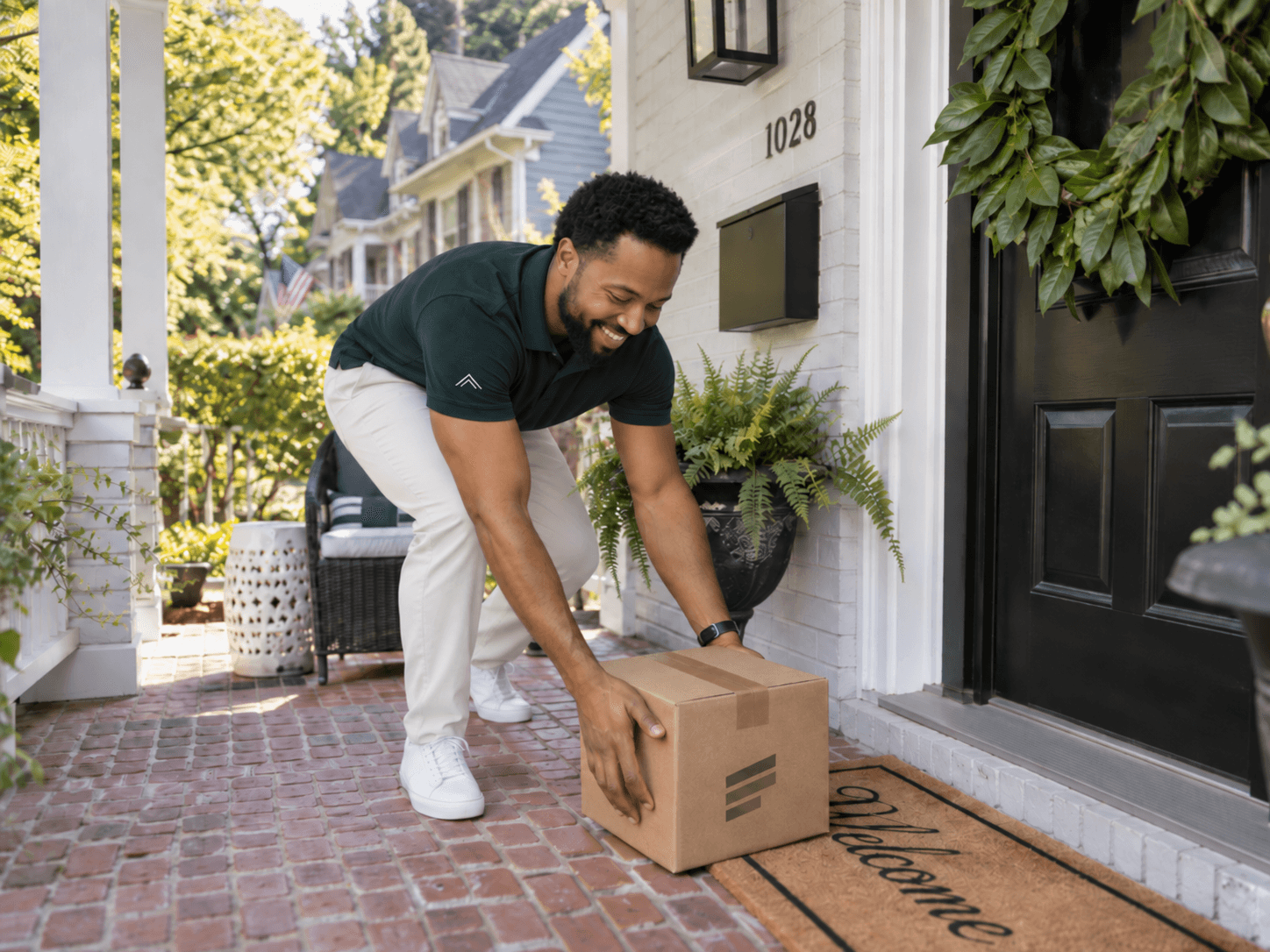 A Housemate team member setting a package down at a member's front door.